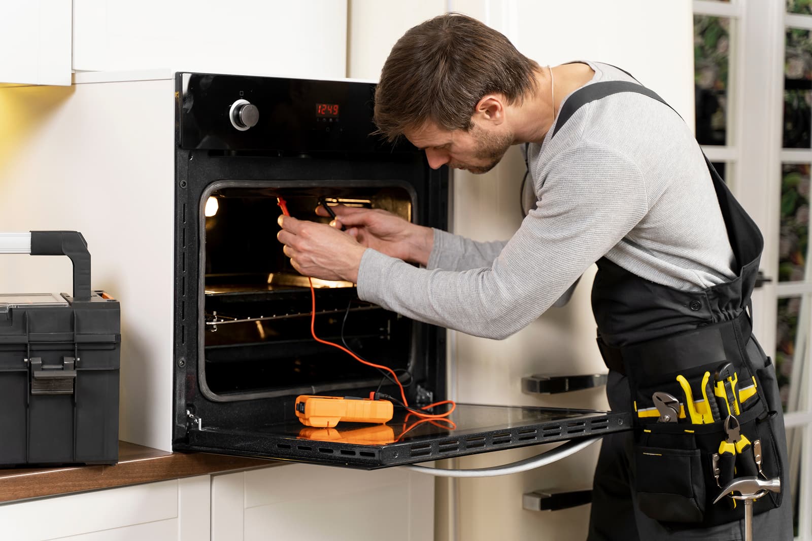 Technician repairing an oven